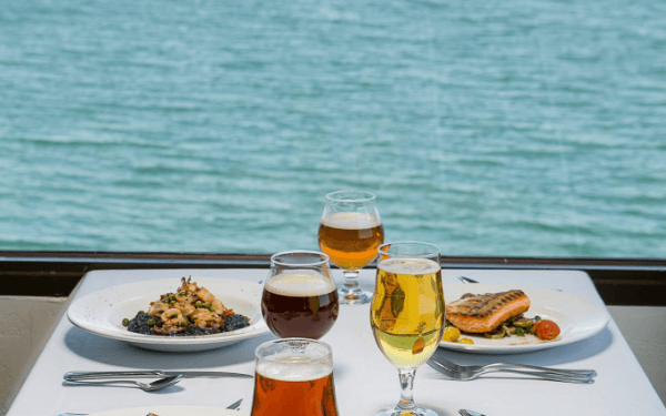 Lunch by the ocean with beer and salmon