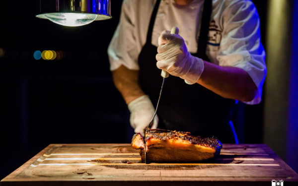 man carving meat