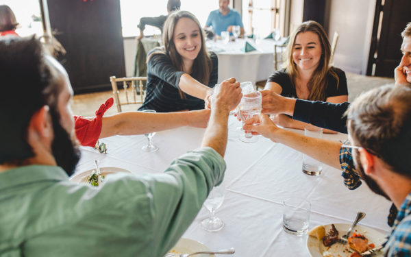 people cheersing around a table