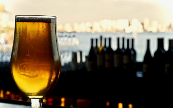 a beer with a view of the ocean behind it